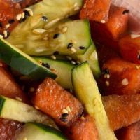 Cucumber Watermelon Salad · Cucumber and watermelon slices seasoned with sesame oil and shoyu, topped with sesame seeds.