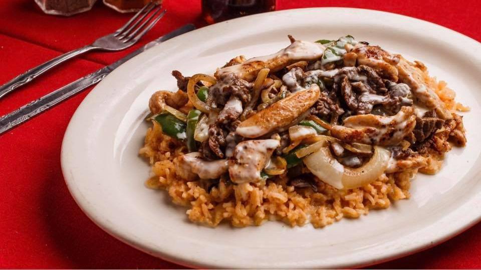 Happy Plate · Grilled chicken and steak with onions and bell peppers. Served on bed of rice, topped with cheese sauce with three tortillas.