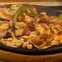 Sizzling Fajitas · Grilled steak or chicken grilled with onions and bell peppers. Served with rice and beans to...