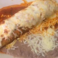 Grilled Burrito · One steak or chicken burrito topped with green and cheese sauce. Served with rice and beans.