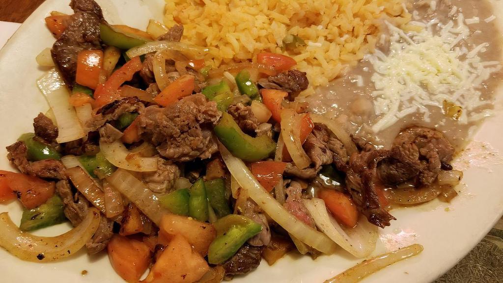 Carne Picada · Grilled steak or tender chicken cooked with chopped onions, tomatoes and bell peppers. Served with rice and beans.