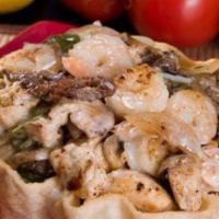 Taco Salad Deluxe · Fried flour tortilla bowl filled with lettuce, rice, grilled chicken, steak, shrimp, onions ...