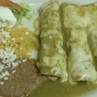 Enchiladas Verdes · Three chicken enchiladas topped with cheese and green salsa. Served with rice and beans with...