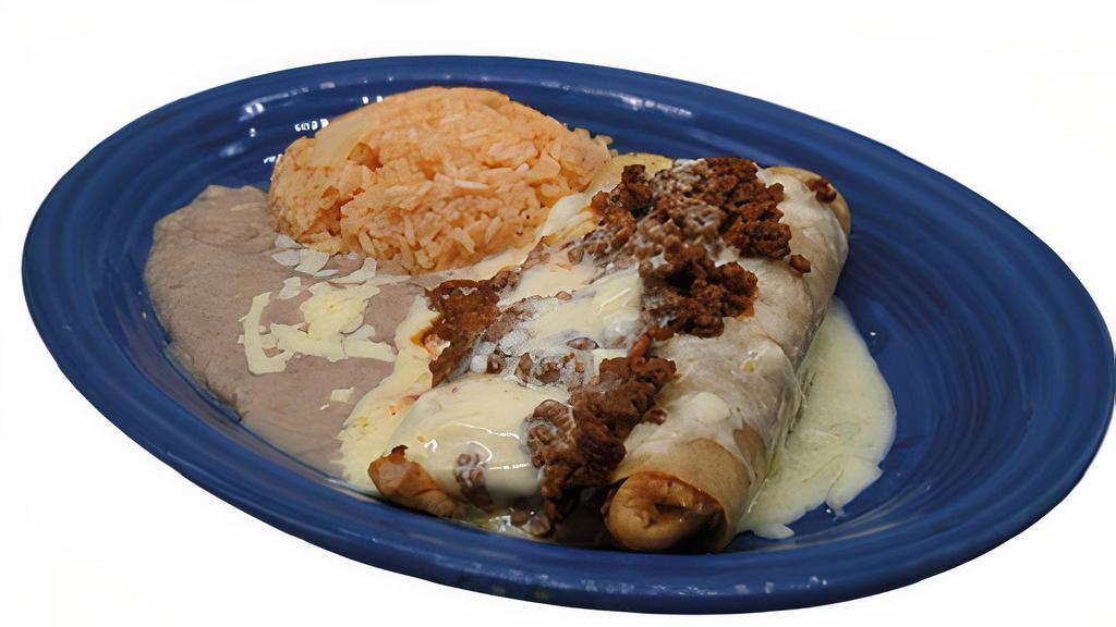 Grilled Enchiladas  · Two grilled steak or chicken enchiladas. Topped with cheese sauce & chorizo. Served with rice & beans.