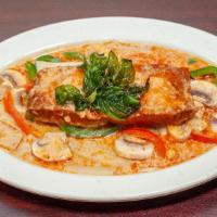 Salmon Curry · Seared salmon topped with creamy red curry, bamboo shoots, and bell peppers, topped with bas...