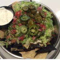 Bo'S Dog Bowl Nachos · Corn Tortillas hand cut and fried fresh daily, our homemade chili, Italian sausage, re fried...