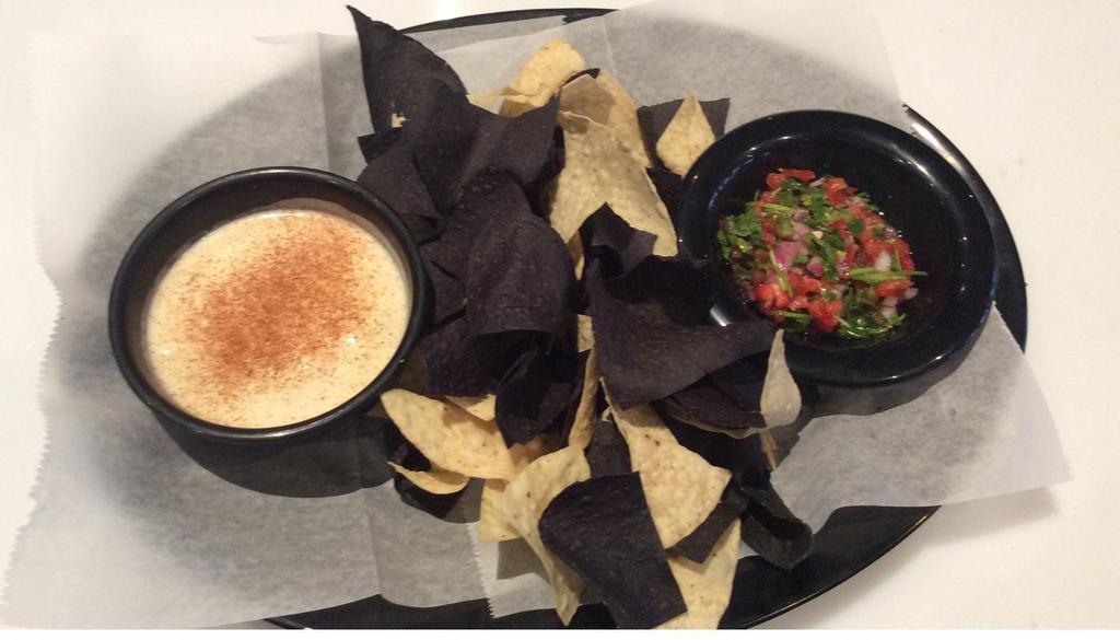 Queso, Pico And Chips · Hand cut and fried fresh corn tortilla chips served with our homemade queso and freshly made in house pico de gallo.