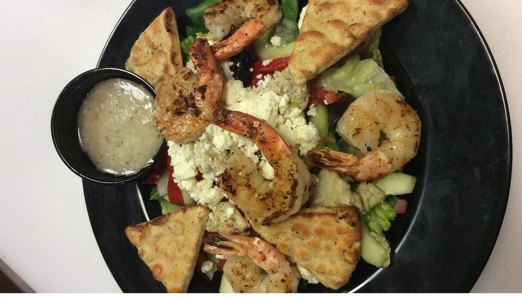 Greek Salad · Crisp mixed greens tossed with kalamata olives, feta cheese, roasted red peppers, marinated artichokes, cucumbers, and tomatoes. Served with feta cheese vinaigrette and pita point