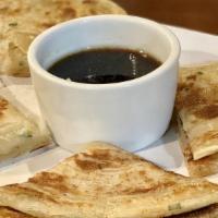 Scallion Pancakes (2) · Savory, unleavened flatbread folded with oil and minced scallions.
