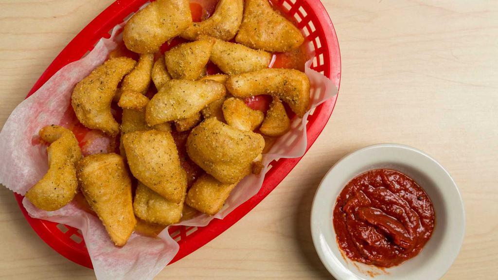 Crack Bread · Fresh bread bites rolled in garlic butter and topped with our special pizza crack. Served with garlic butter or marinara sauce. Add dipping sauce for an additional charge.