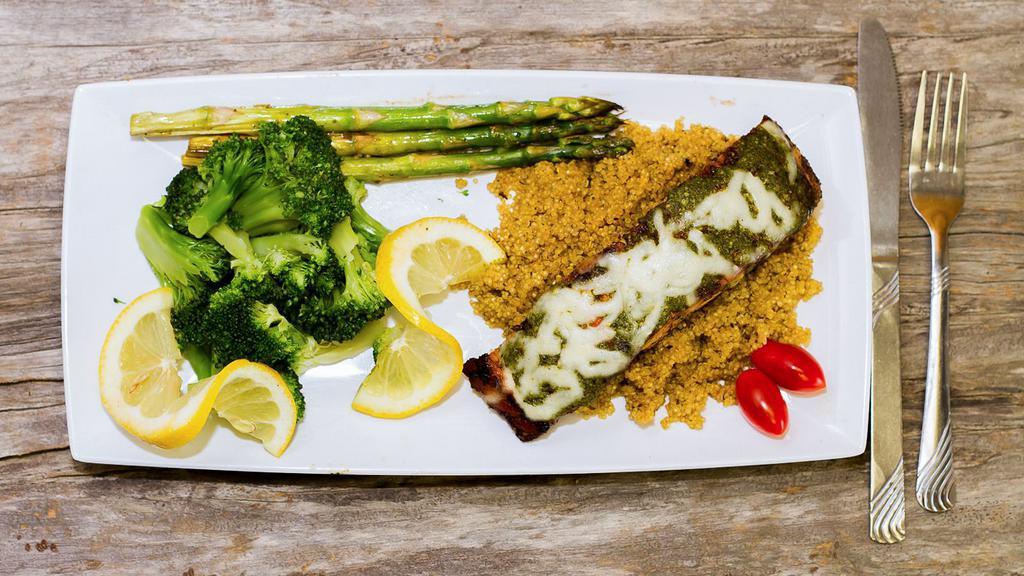 Salmon · Cooked to perfection, fresh salmon with a specialty delicious green sauce cook in white wine and lemon. Served with rice, broccoli and asparagus.