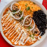 Red Chilaquiles · Local tortillas, sauteed in red chile sauce that will JUMP on you. Topped with carnitas, che...