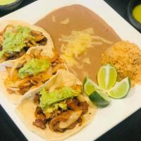 Plato De Taco / Taco Plate · Tres tacos con tu elección de carne. Servidos con arroz y frijoles. / Three tacos with your ...