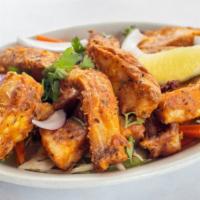Amritsari Machli (Fish) · Fish pieces coated with a delicately spiced gram flour batter, golden fried and served with ...