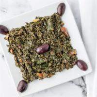 Berber Spinach · Freshly steamed spinach, authentic chermoula sauce, tomatoes and olives, served with homemad...