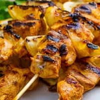 Berber Style Chicken Brochettes · Chicken breast skewers served with yellow rice and cucumber salad.