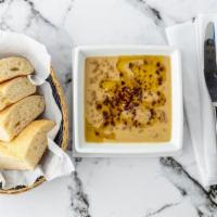 Bysar · Traditional split pea soup garnished with olive oil, cumin, and pepper, served with spicy ol...