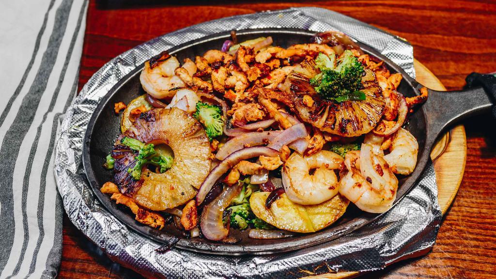 Hawaiian Fajitas · Grilled chicken, shrimp, and pineapple sautéed with yellow squash, green zucchini, red onions. Served with rice, refried beans, salad, sour cream and flour tortillas.