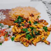 Tiras De Pollo · Strips of grilled chicken topped with cilantro, and sautéed with a savory combination of che...