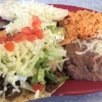 Tostada, Rice, & Beans Combo · Ground beef or shredded chicken with ranchera sauce, chile con queso, and white cheese.