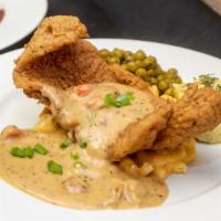 Mardi Gras Mambo · Fried fish served over macaroni and cheese topped with shredded cheddar cheese and our signa...