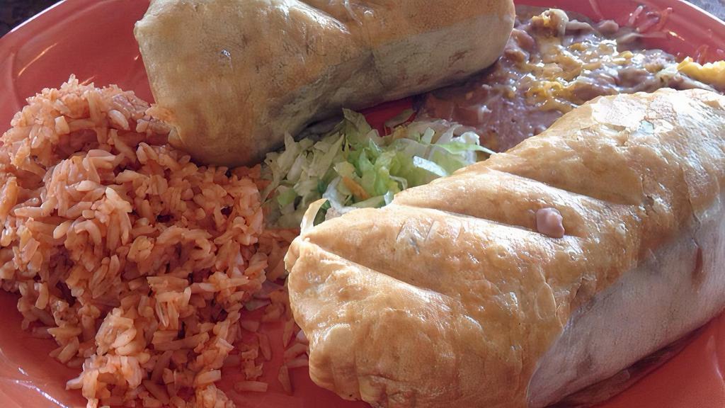 Chimichangas · Most popular. Two crispy fried flour tortillas filled with shredded meat or shrimp covered with our own cheese sauce, beans, and guacamole salad.
