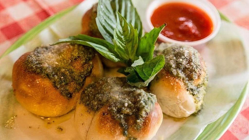 Garlic Knots · 4 pieces. with sauce.