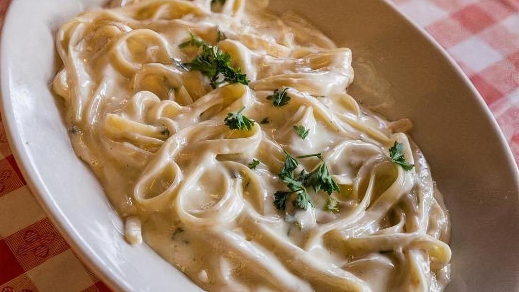 Fettuccini Alfredo · Served with garlic rolls and house salad.