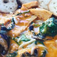 Divine Portobello · Plump portobello mushrooms, juicy roasted chicken breast, and fresh spinach sautéed in a cre...