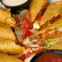 Taquitos · Crisped corn tortillas filled with chicken or ground sirloin and cheese served with lettuce,...