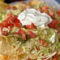 Nachos · Your choice of foundation with queso, cheese, sour cream and pico de gallo.