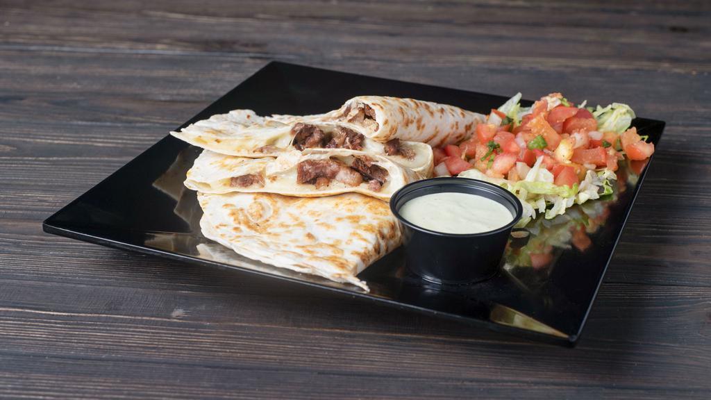 Grilled Quesadilla · Your choice of foundation with roasted garlic sauce and cheese, melted in a tortilla, served with lettuce and pico de gallo.