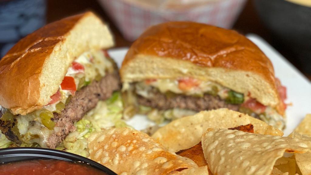 Green Chili Burger · Ground sirloin seasoned with mild green chilis, shredded jack cheese, lettuce, pico de gallo - topped with tomatillo sauce.
