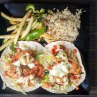 Shrimp Tacos · Flour tortilla tacos dressed with roasted garlic sauce, lettuce, cheese and pico de gallo se...
