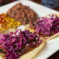 Bbq Tacos (2 Pc) · White corn tortillas, carnitas (pork), Swanky's BBQ sauce, jicama slaw, served with pinto be...
