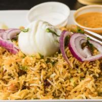 Chicken Biryani · Indian spices marinated chicken cooked with fragrant basmati rice (served with egg, gravy an...