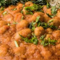 Chickpeas Curry · Chickpeas cooked with Indian spiced curry sauce, garnished with fresh cilantro.