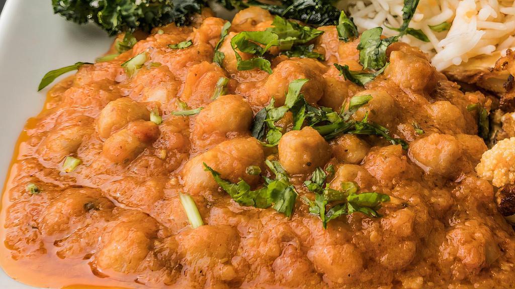 Chickpeas Curry · Chickpeas cooked with Indian spiced curry sauce, garnished with fresh cilantro.