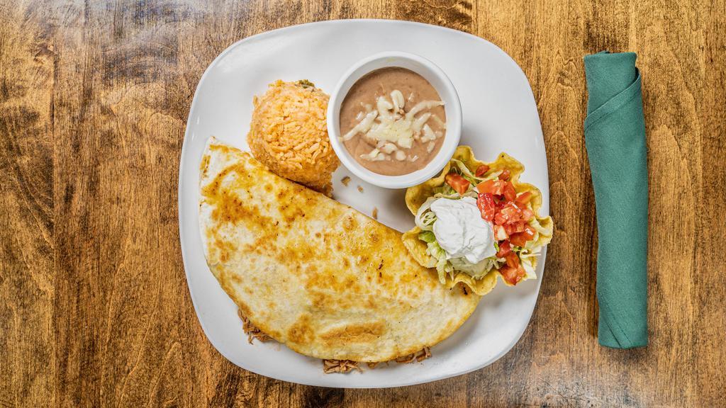 Quesadilla Grande (Beef Or Shredded Chicken) · Flour tortilla filled with cheese and your choice of meat. Served with rice, beans lettuce, tomatoes and sour cream.
