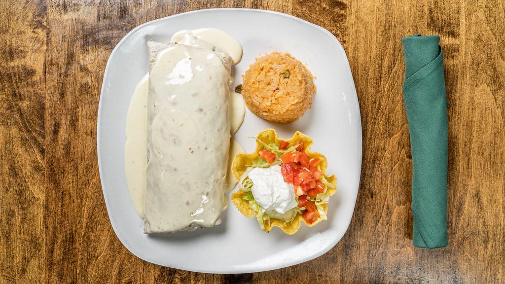 Burrito Gigante · Large flour tortilla filled with ground beef and beans, topped with cheese sauce. Served with rice, lettuce, tomato and sour cream.