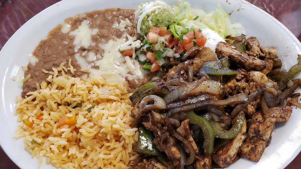 Chicken Fajita · Grilled chicken with onion, bell pepper and tomatoes. Served with rice, beans, lettuce, sour cream, guacamole, tomatoes and corn or flour tortillas.