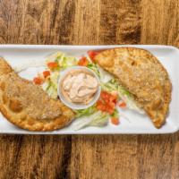 Chicken Empanadas · Fried pastry dough stuffed with chicken, served with chipotle sauce.