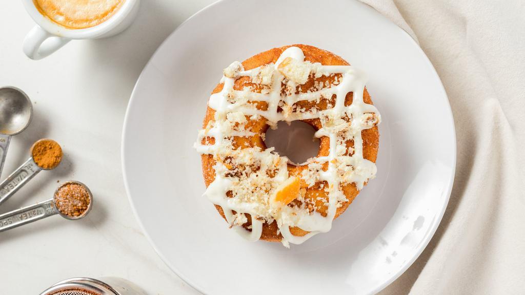 Cinnamon Crunch · A cinnamon tossed yeast donut with cream cheese drizzle and topped with cinnamon crumble.