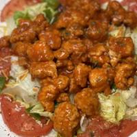 Cajun Chicken Salad · Mixed greens with tomatoes, onions, and croutons topped with lightly battered fried chicken ...