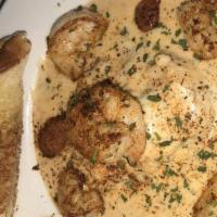 Shrimp & Grits · Cheesey grits served with andouille sausage and blackened shrimp, with Texas toast.