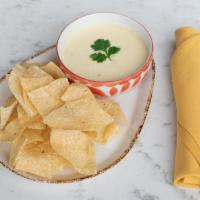 Queso Dip · Melted cheese, charro onions, crispy tortillas.