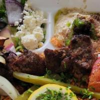 Mix Grill Platter · One skewer of chicken, one skewer of lamb, one skewer of kabob, hummus, rice and salad.