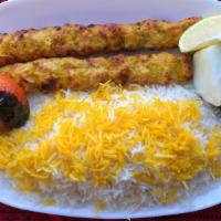 Chicken Kubideh · Two skewers of ground chicken kabobs with white rice and grilled tomato.