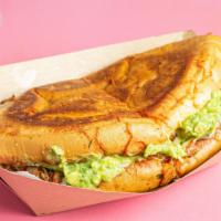 Torta · Mexican hoagie seared in consome,
birria beef, toasted Chihuahua cheese, avocados, chile de ...