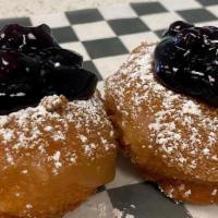 Donut Of The Week · Blueberry French Toast- Maple icing, cinnamon, powdered sugar, and blueberry topping!